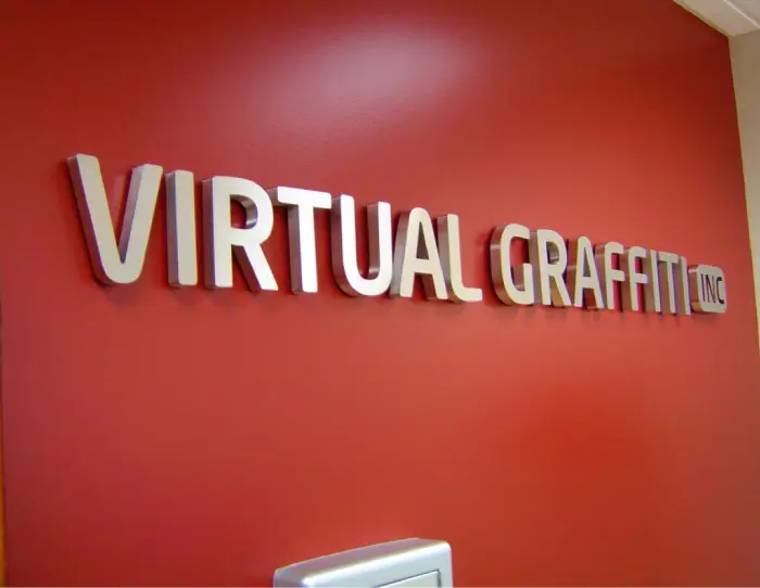 A red wall with the words virtual graffiti on it.