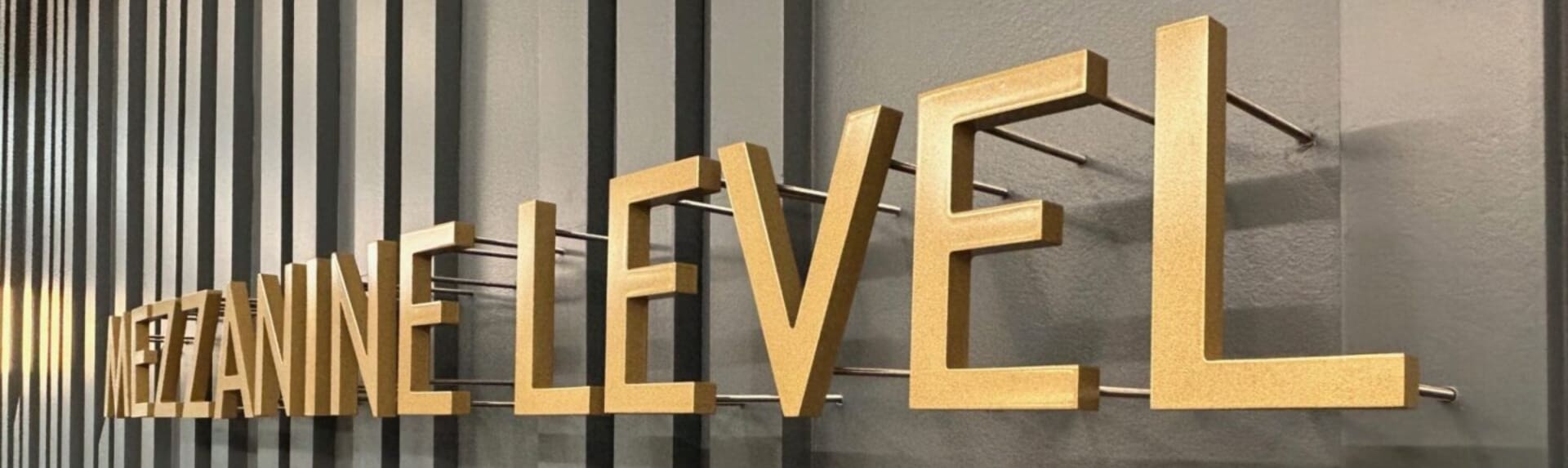 A sign that says believe in gold letters.